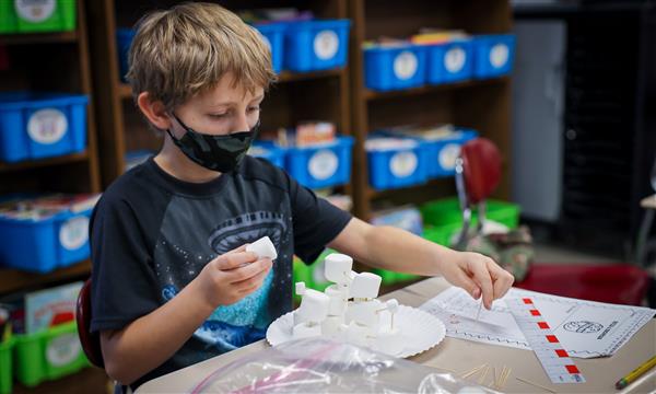 Boy builds marshmallow tower